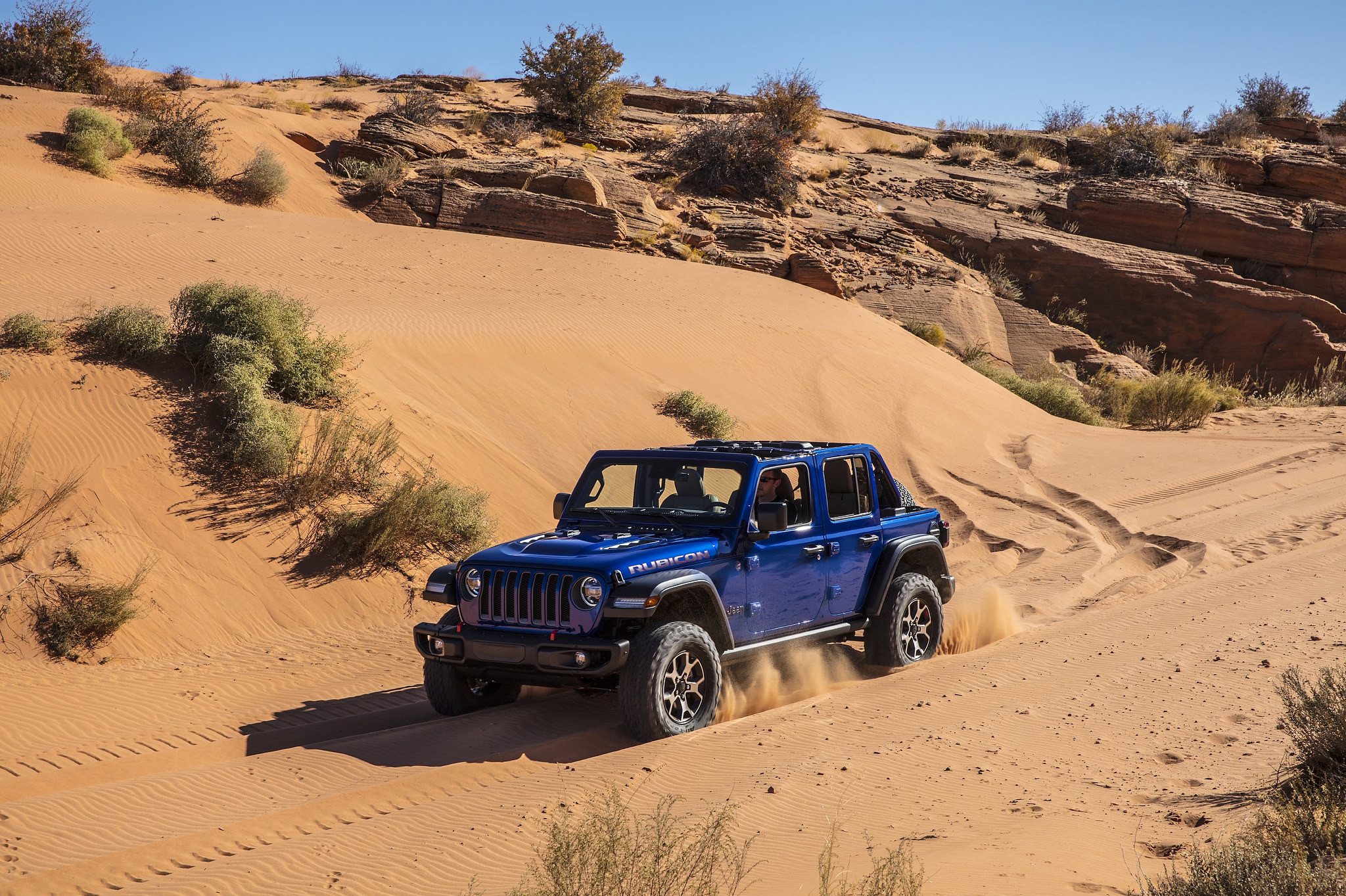 A 2021 Jeep Wrangler driving in the sand