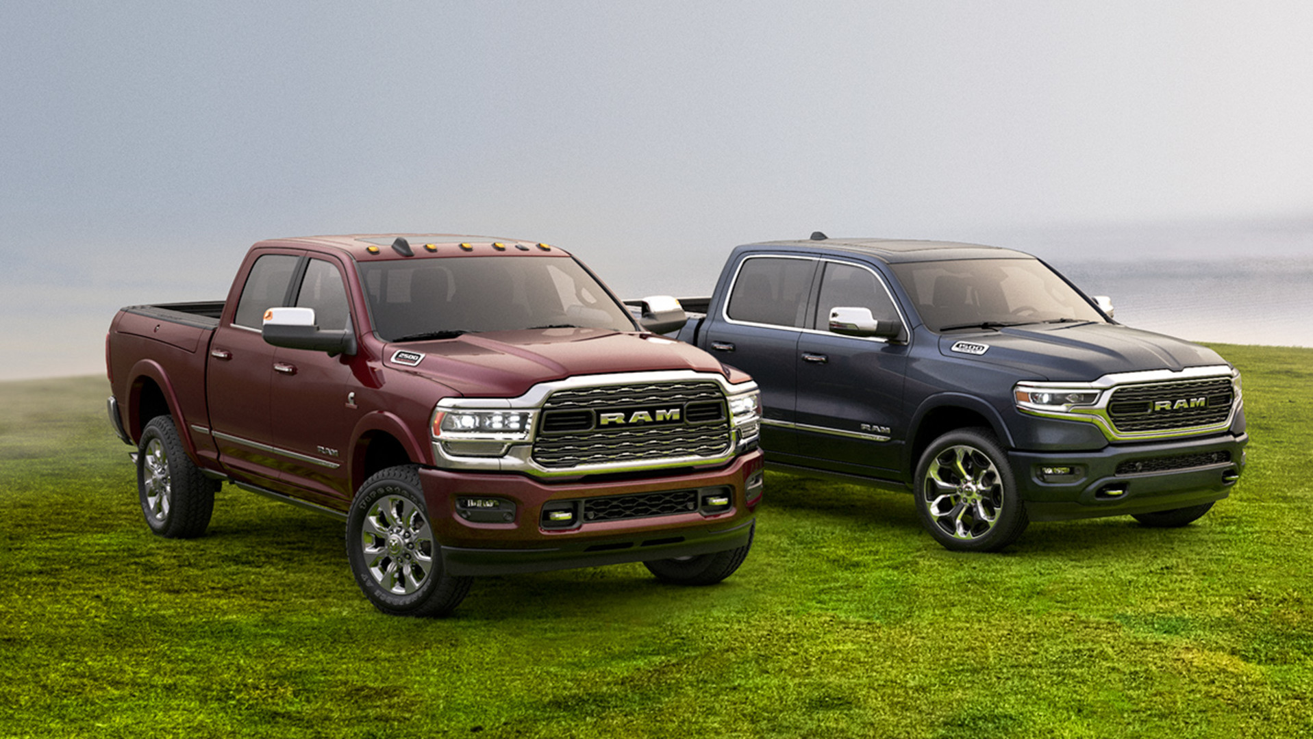 Three Quarter view of red and blue Ram 1500 and Ram 2500 pickup truck parked on grass.