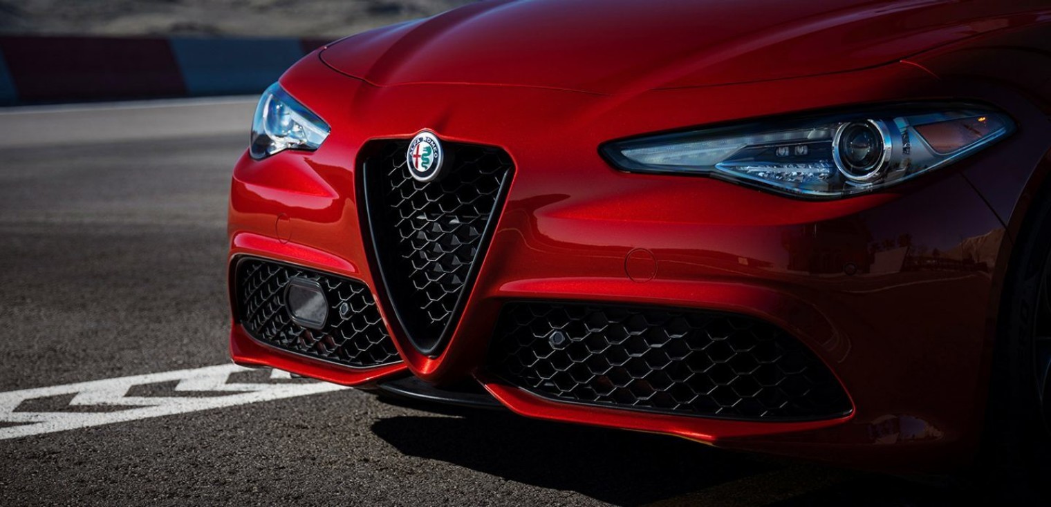 Front view of the red 2019 Alfa Romeo Giulia showing its Bi-Xenon headlights and the Scudetto grille