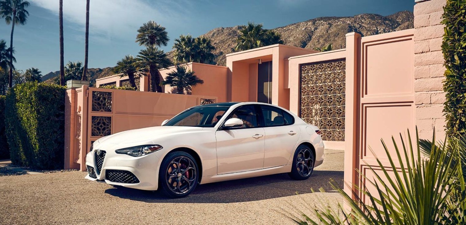 Side view of the white 2019 Alfa Romeo Giulia pulling out of a driveway