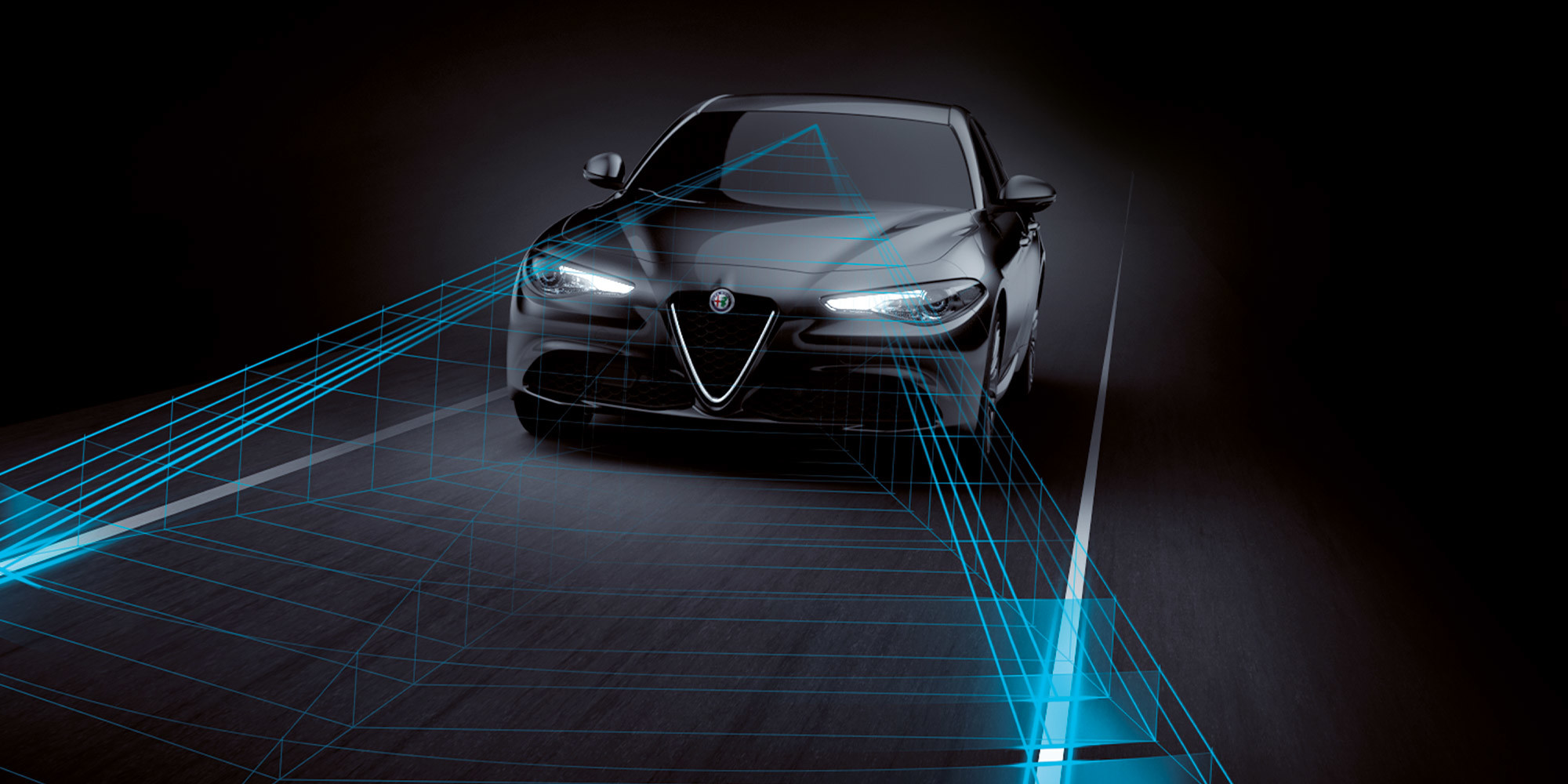 An overhead view of a black Alfa Romeo Giulia with illustrated blue sensor lines spanning the space between the front windshield and the vehicle in front of it. Illustrated speedometers are overlaid on each vehicle.