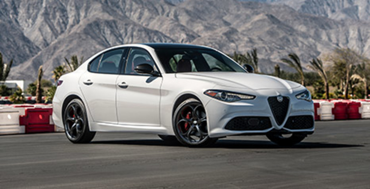 Front quarter view of a withe Alfa Romeo Giulia, parked on a race track