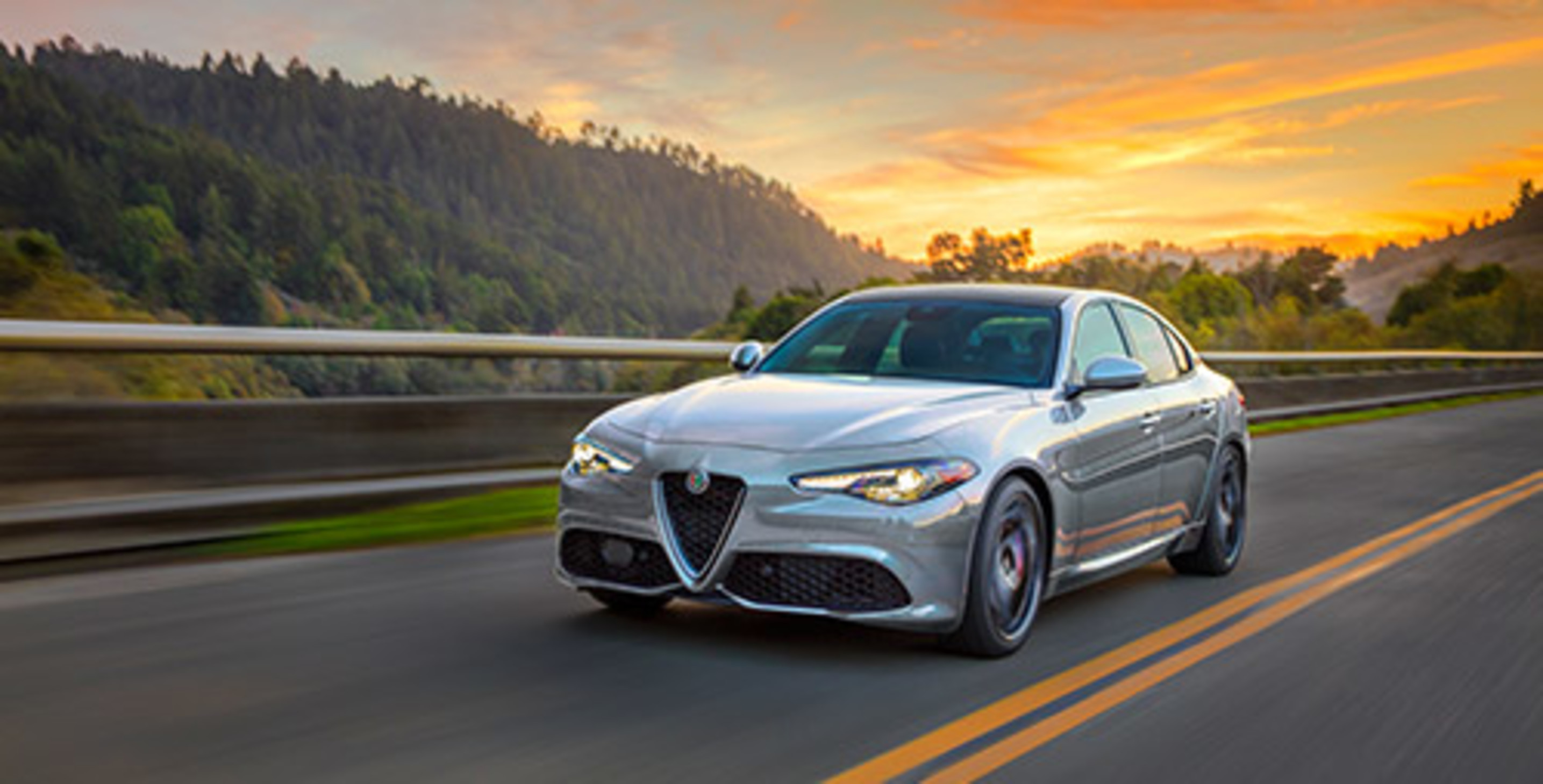 Silver 2021 Alfa Romeo Giulia being driven on the highway at sunset
