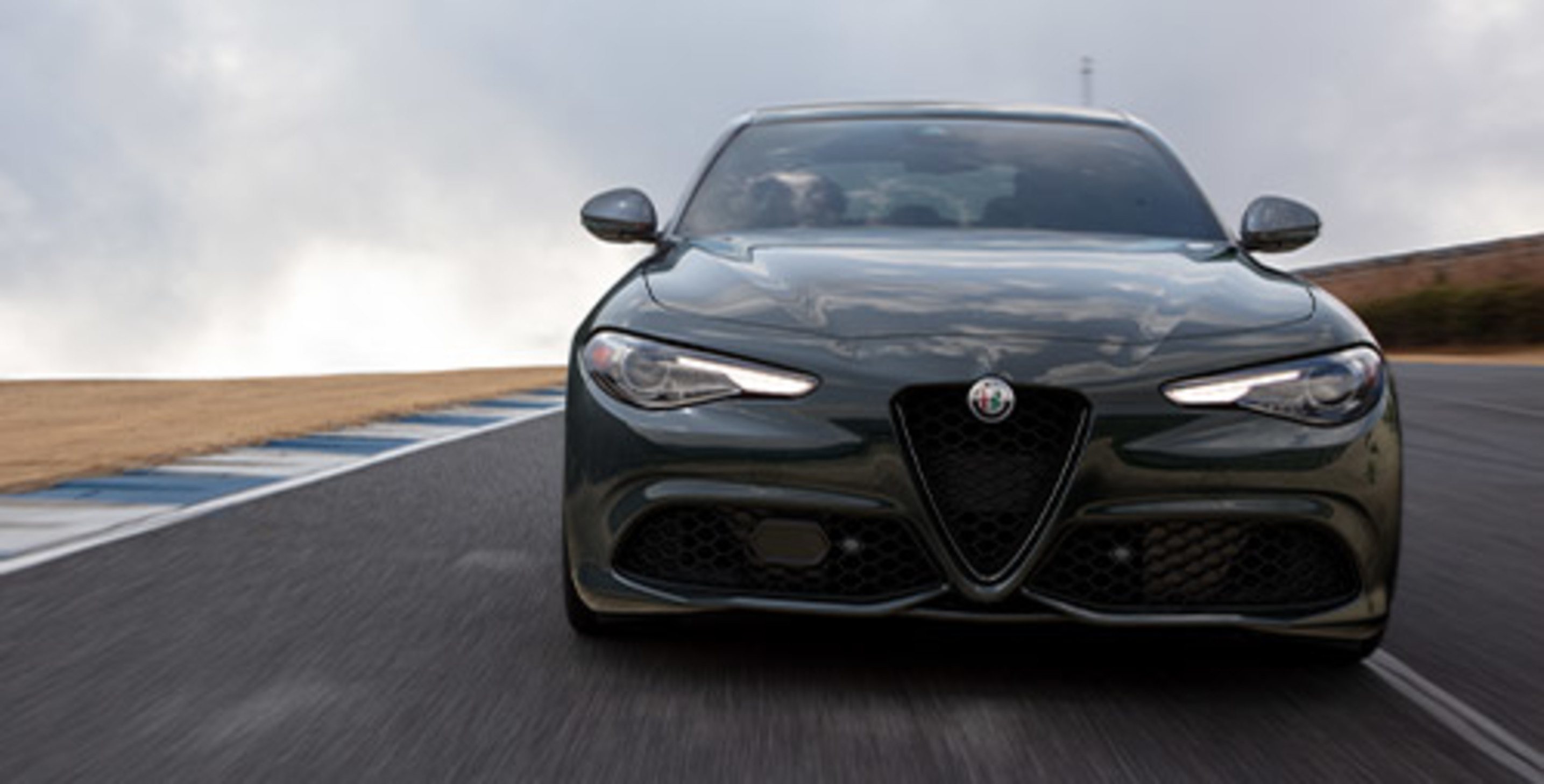 Front view of Grey 2021 Alfa Romeo Giulia being driven fast on the road