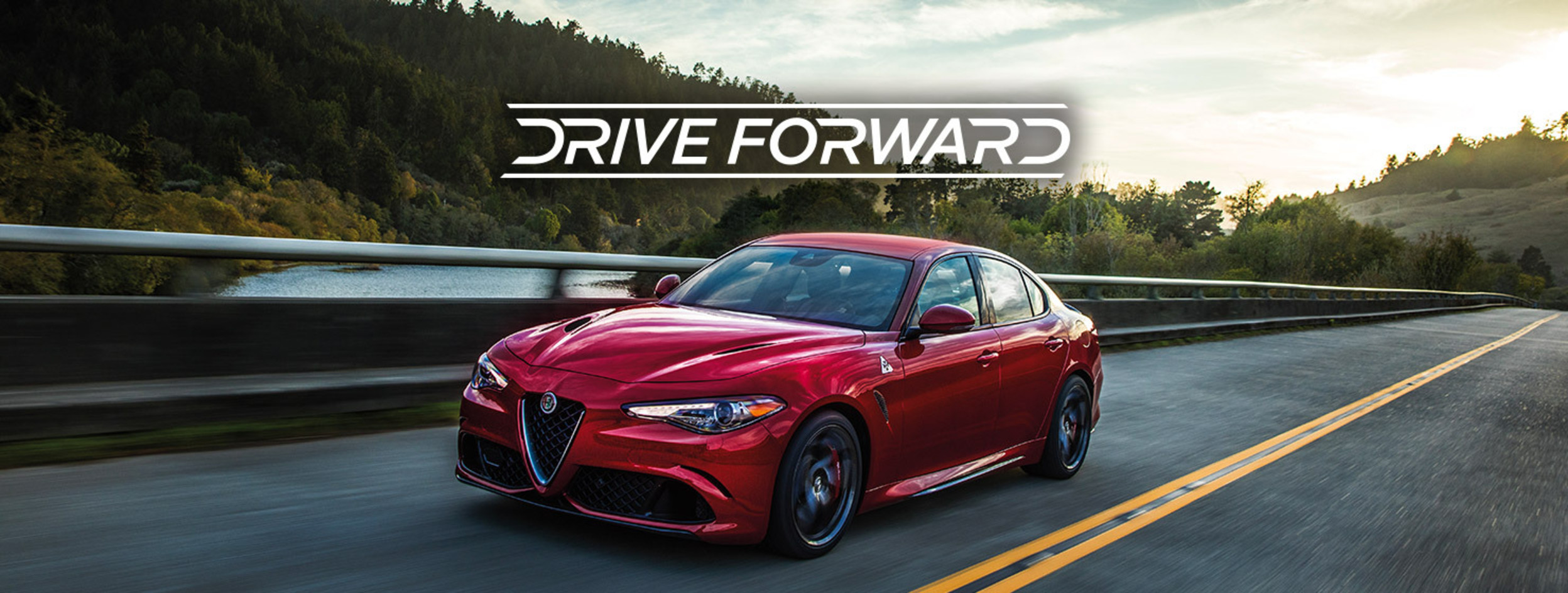 Drive Forward. Red 2020 Alfa Romeo Giulia being driven on the road.