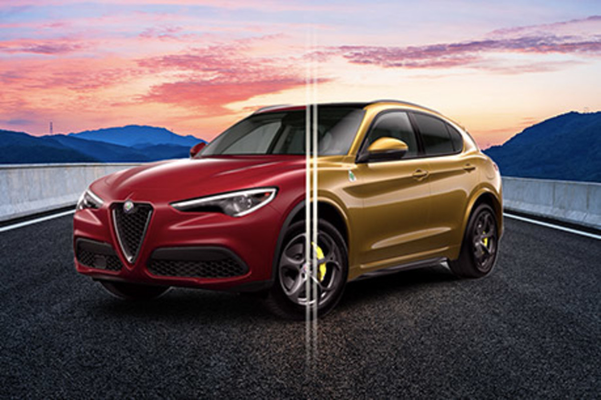 Alfa Romeo Giulia rouge garée sur une route pavée fissurée avec des montagnes rocheuses en arrière-plan.