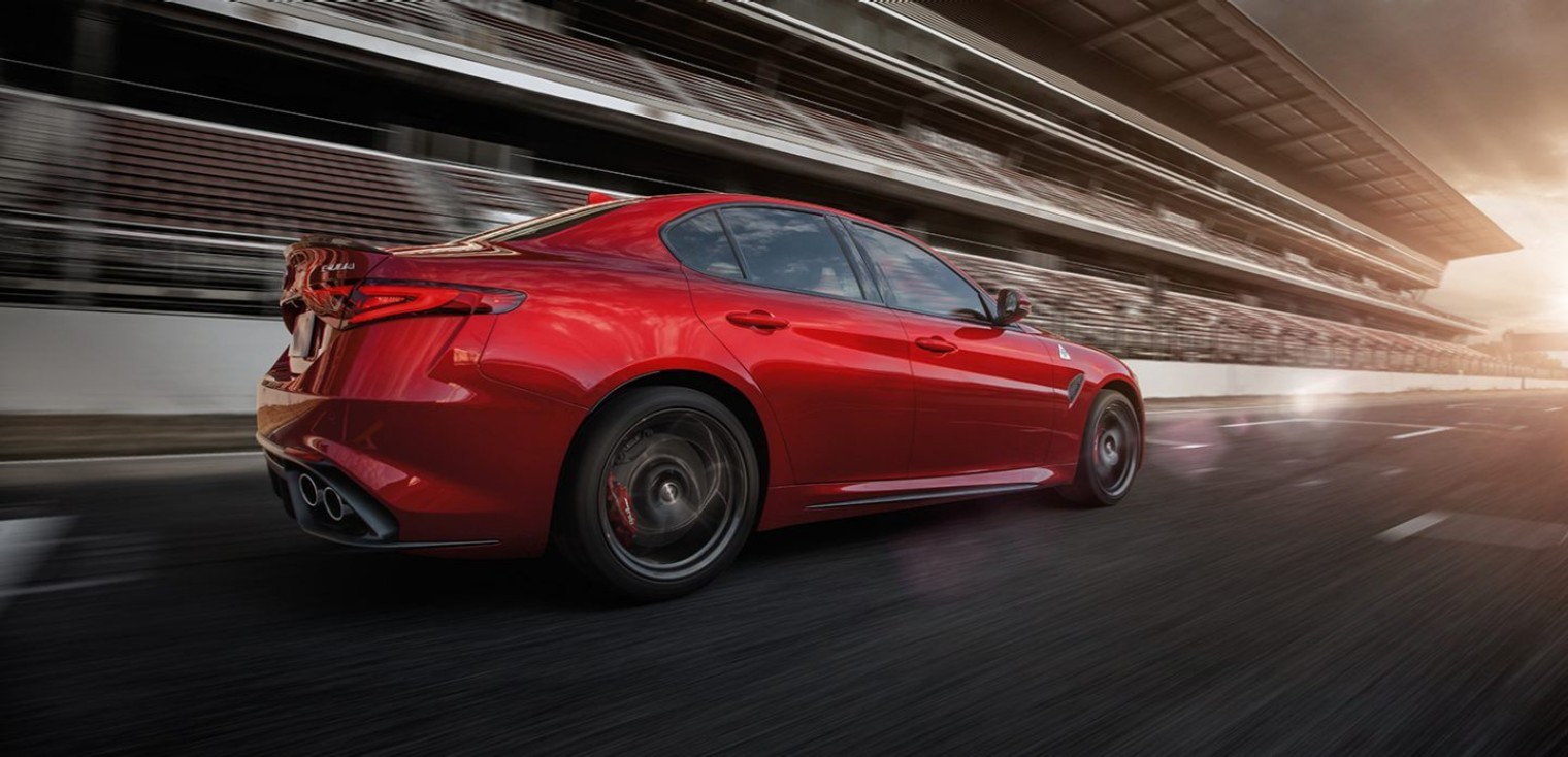 Rear view of the red 2019 Alfa Romeo Giulia Quadrifoglio driving on a race track