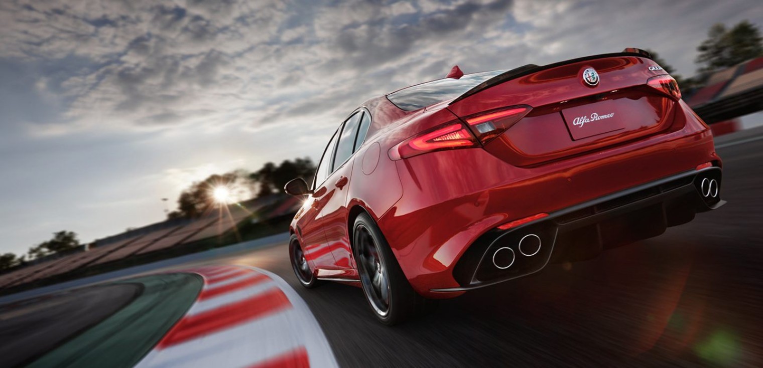 Rear view of the red 2019 Alfa Romeo Giulia Quadrifoglio being driven on a race track