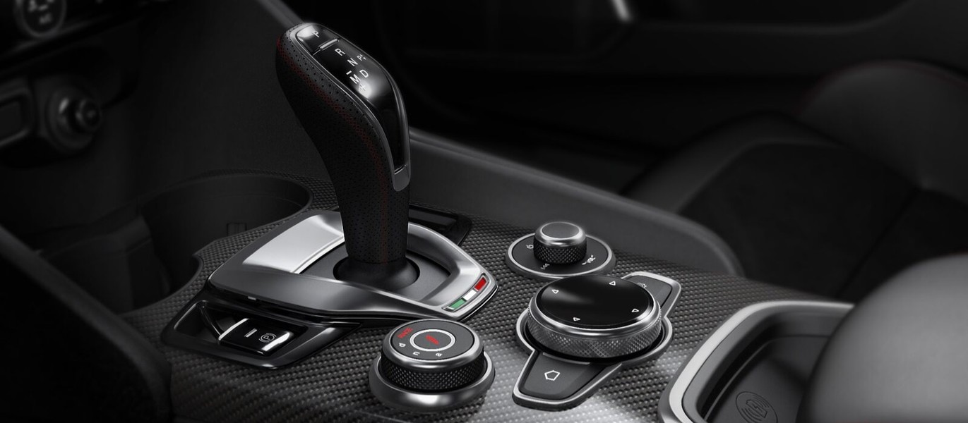 The console on the 2021 Alfa Romeo Giulia Quadrifoglio focusing on the gear shifter, Drive Mode Selector and rotary pad.