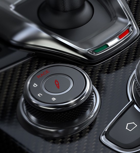 The console on the 2021 Alfa Romeo Giulia Quadrifoglio focusing on the gear shifter, Drive Mode Selector and rotary pad.