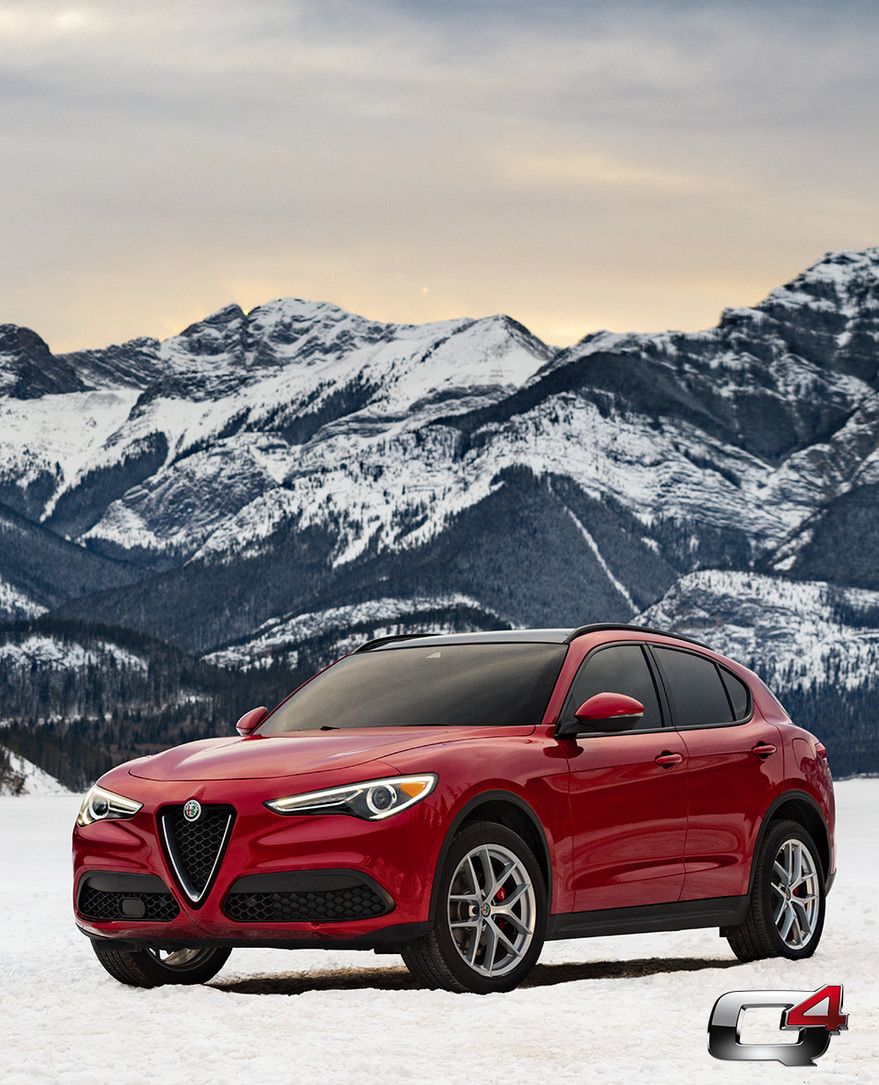 Front view of the red 2019 Alfa Romeo Stelvio parked in the mountains