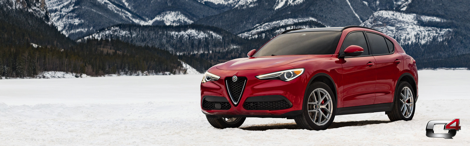 Front view of the red 2019 Alfa Romeo Stelvio parked in the mountains