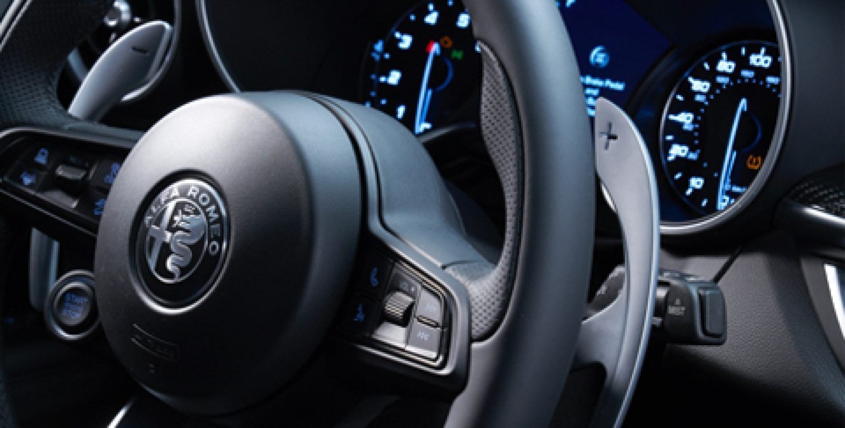 A close-up of the steering wheel in the 2020 Alfa Romeo Stelvio, focusing on one of the paddle shifters.