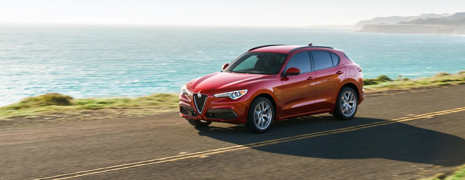 The 2020 Alfa Romeo Stelvio being driven on a coastal road.