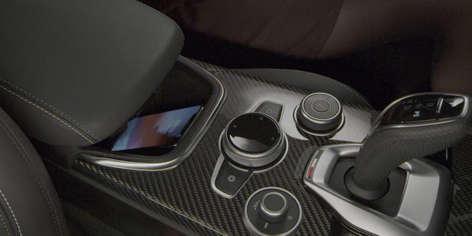A close-up of the wireless charging pocket in the centre console of the 2020 Alfa Romeo Stelvio.