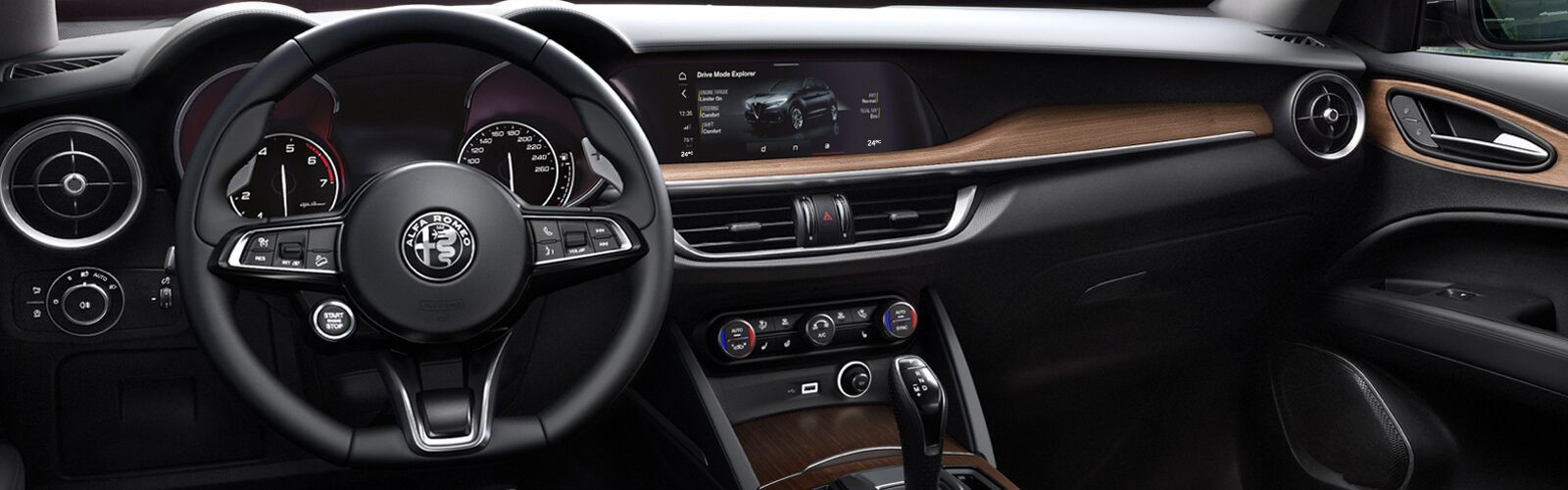 A close-up of the steering wheel and dashboard in the 2020 Alfa Romeo Stelvio.