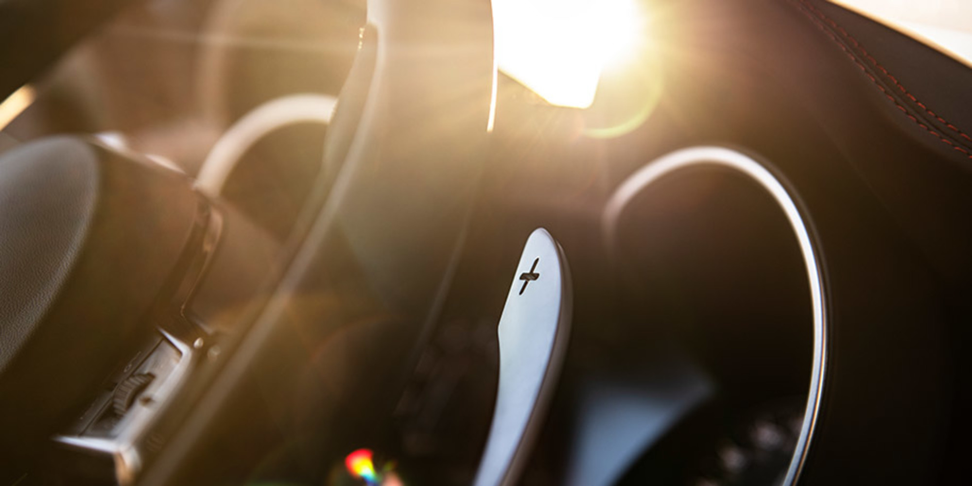 Close up of 2021 Alfa Romeo Stelvio steering wheel with the sun beaming