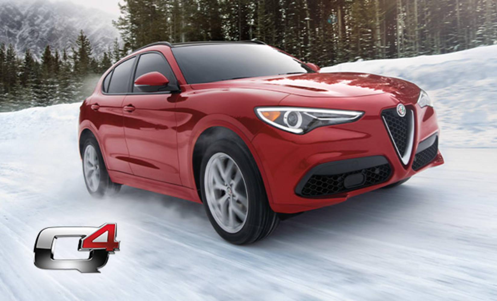 A front view of a red Alfa Romeo Stelvio spraying snow while being driven on a snow-covered road in the mountains.