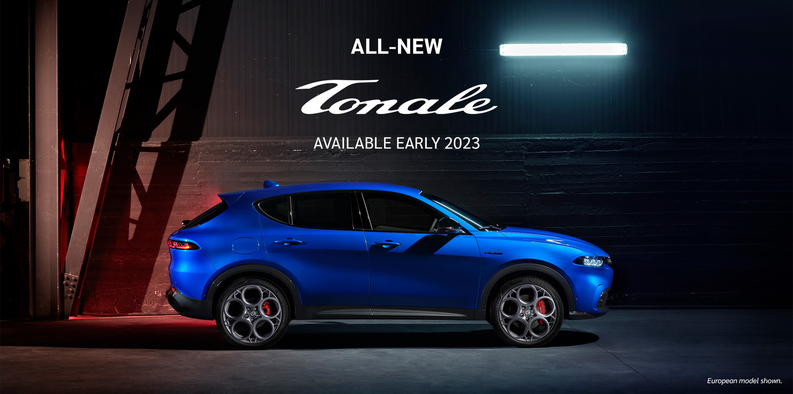 Side view of a parked blue 2023 Alfa Romeo Tonale hybrid SUV.