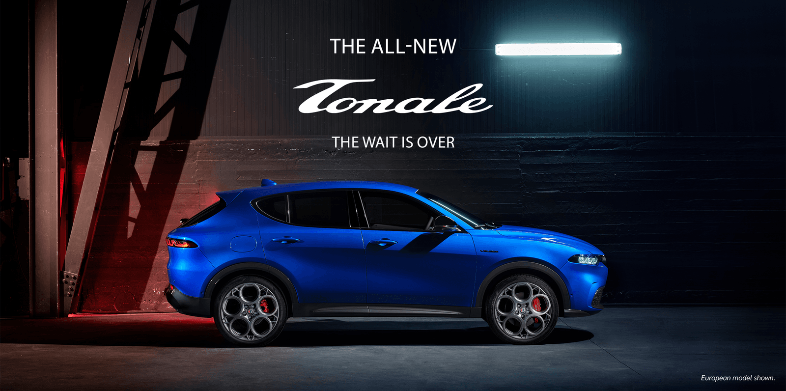 Side view of a parked blue 2023 Alfa Romeo Tonale hybrid SUV.