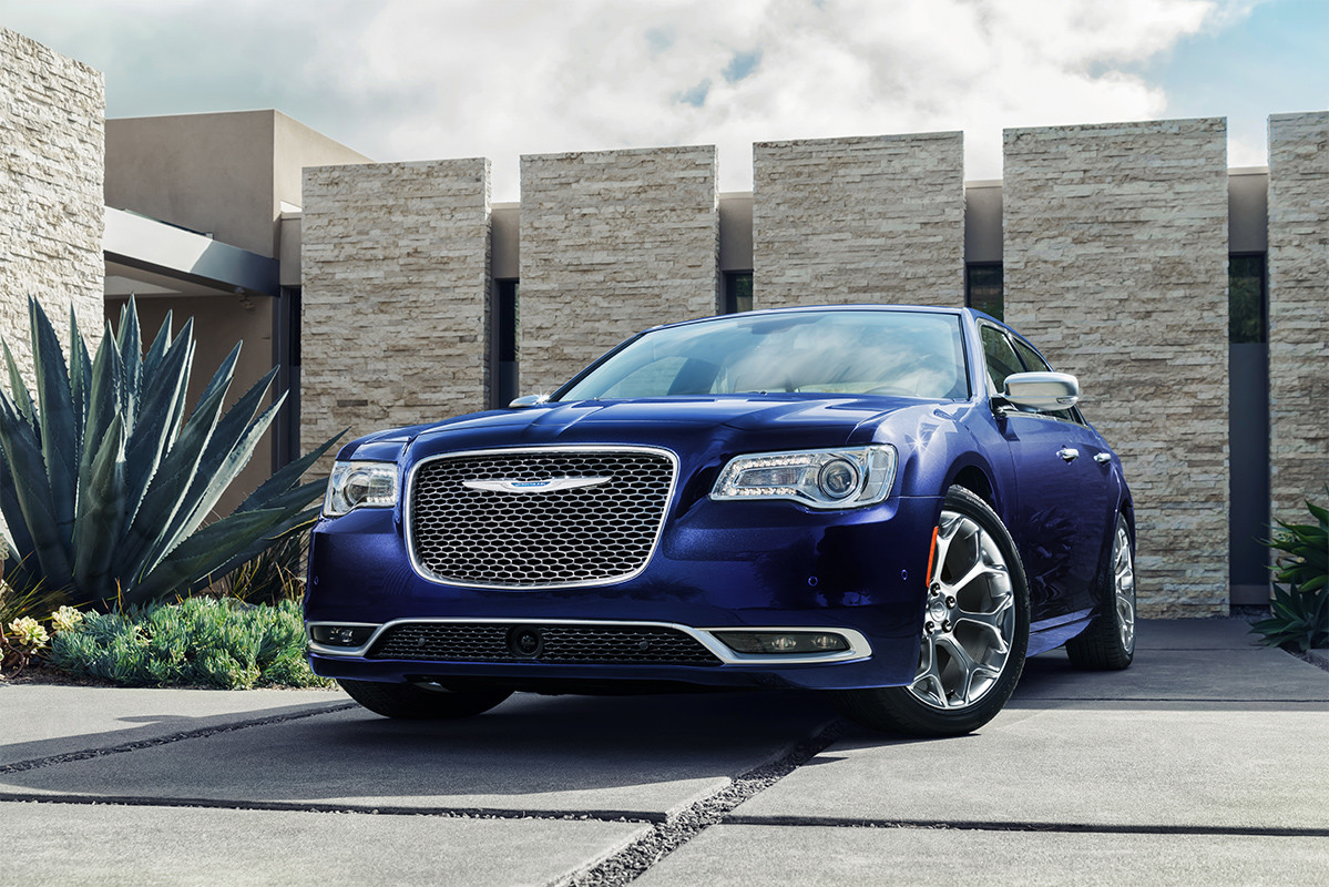 Blue Pacifica 300 Parked in Front of a Luxurious House