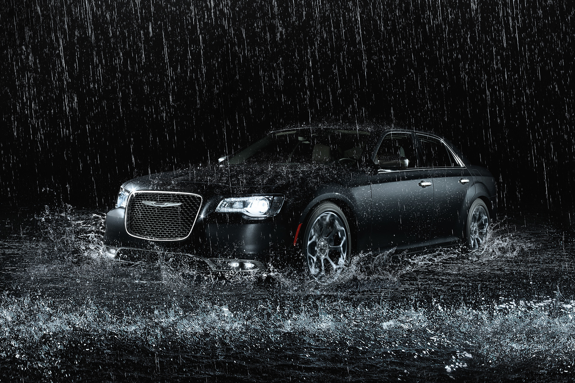 The black 2020 Chrysler 300 parked in a darkened studio