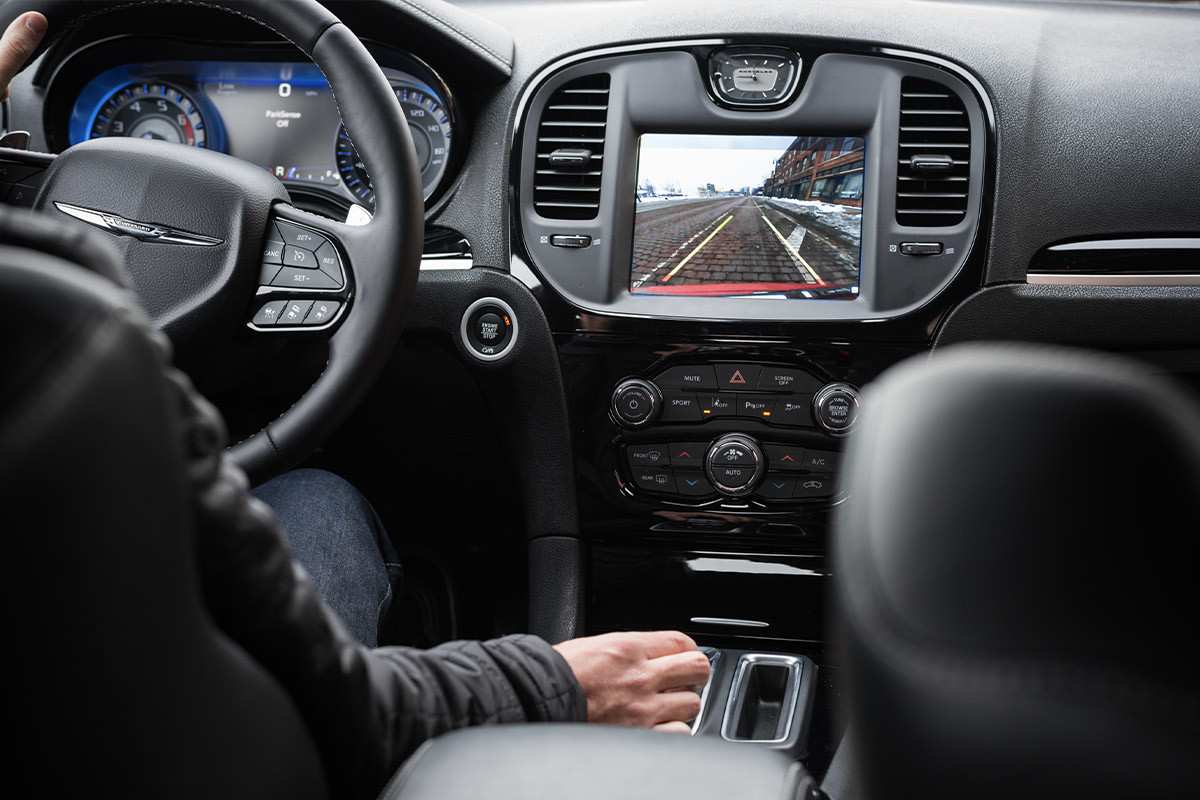 Front interior of a Chrysler 300 in black showcasing the ParkView rear backup camera feature.