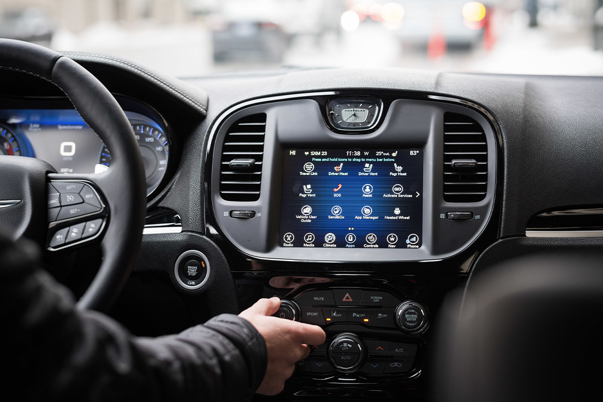 Interior of a Chrysler 300 with focus on the Uconnect 4C multimedia system in a black finish