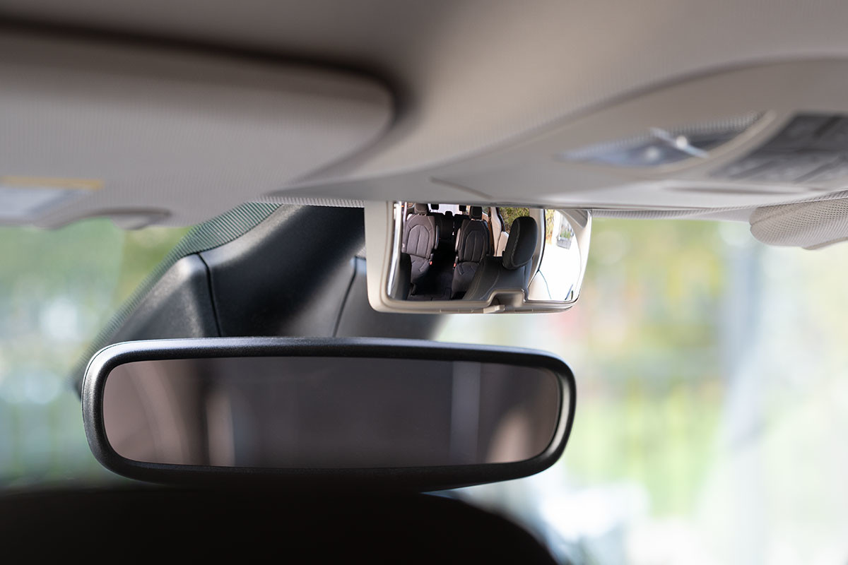 A close-up of the rearview mirror on the 2021 Chrysler Grand Caravan.