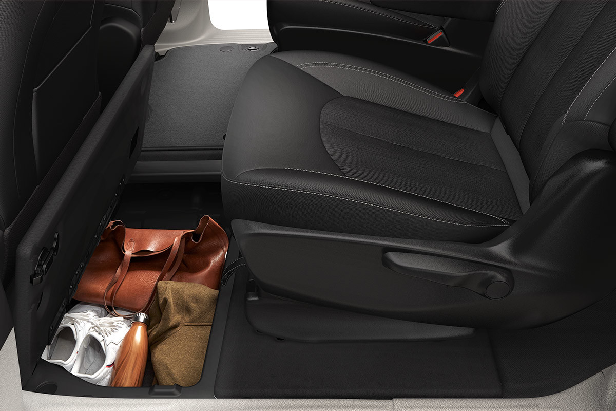 Close up of gear being stored inside the second row Stow ‘n Go inside the 2022 Chrysler Grand Caravan