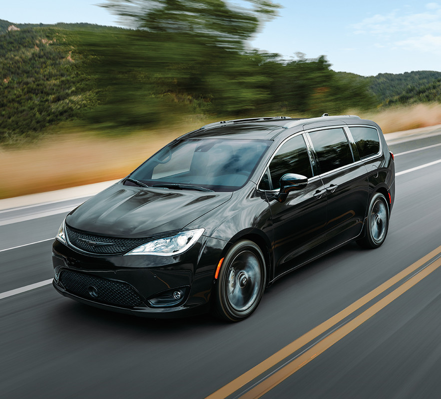 Black 2020 Chrysler Pacifica being driven fast on the road