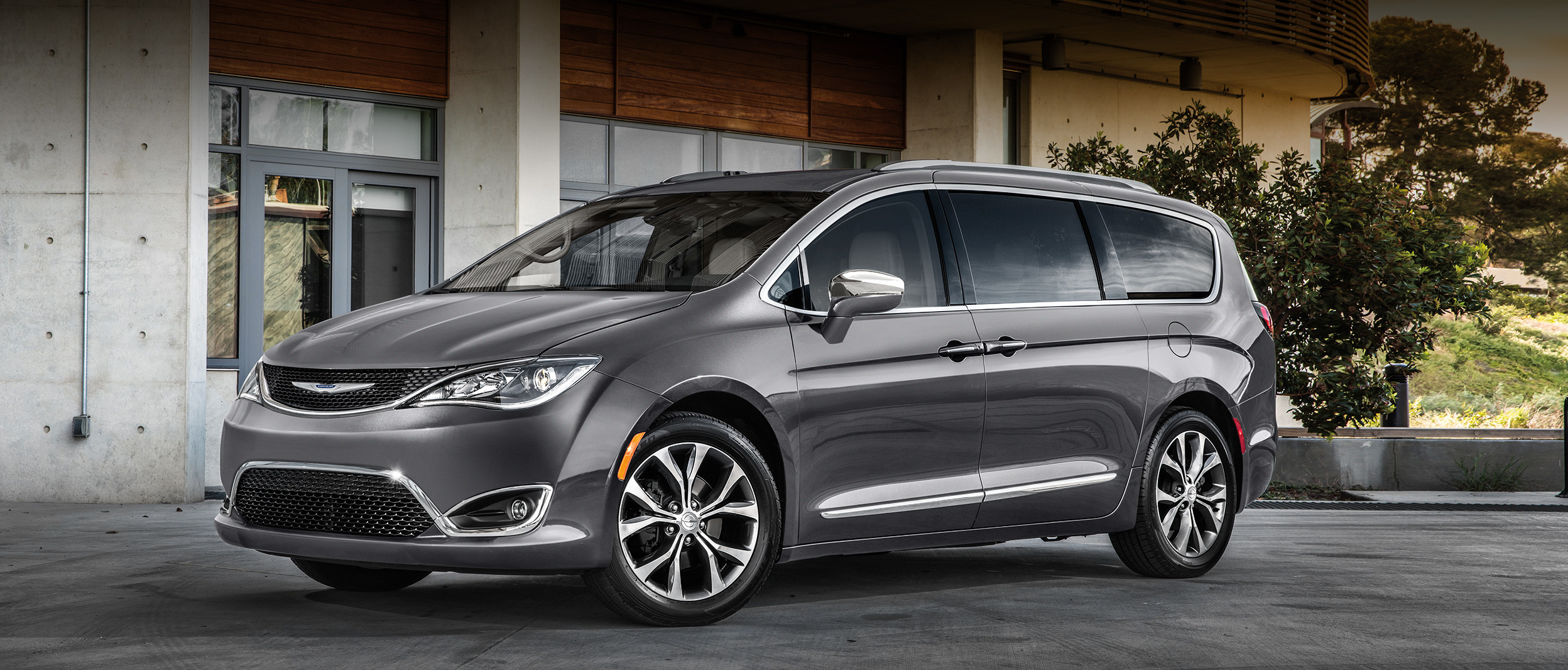 Silver Chrysler Pacifica Driving Through the City