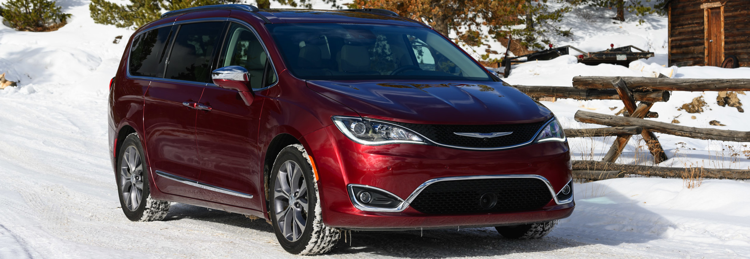 Red 2020 Chrysler Pacific being driven through snow with strong wheel traction