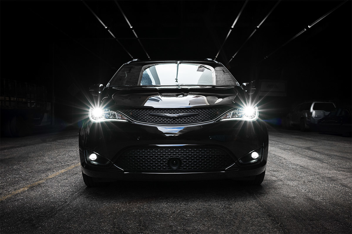 Black 2020 Chrysler Pacifica with its LED headlamps on.