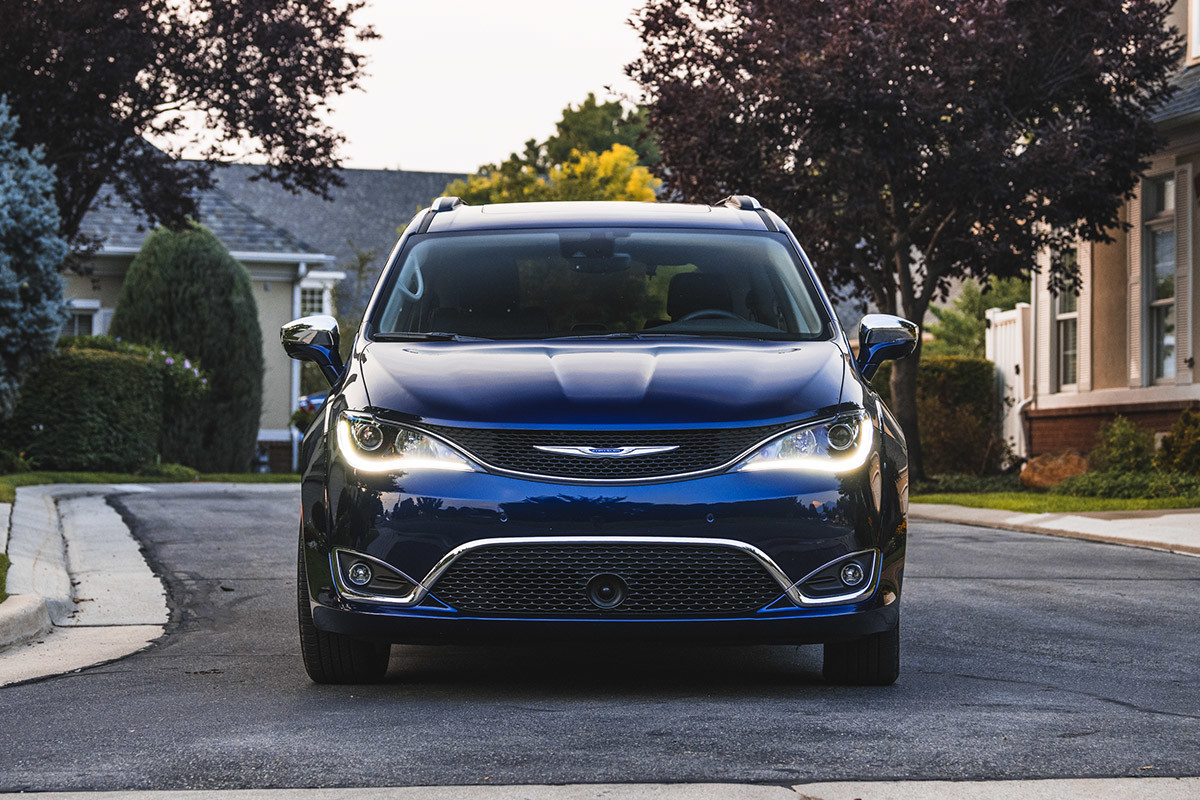 Blue 2020 Chrysler pacifica driving through a residential area.