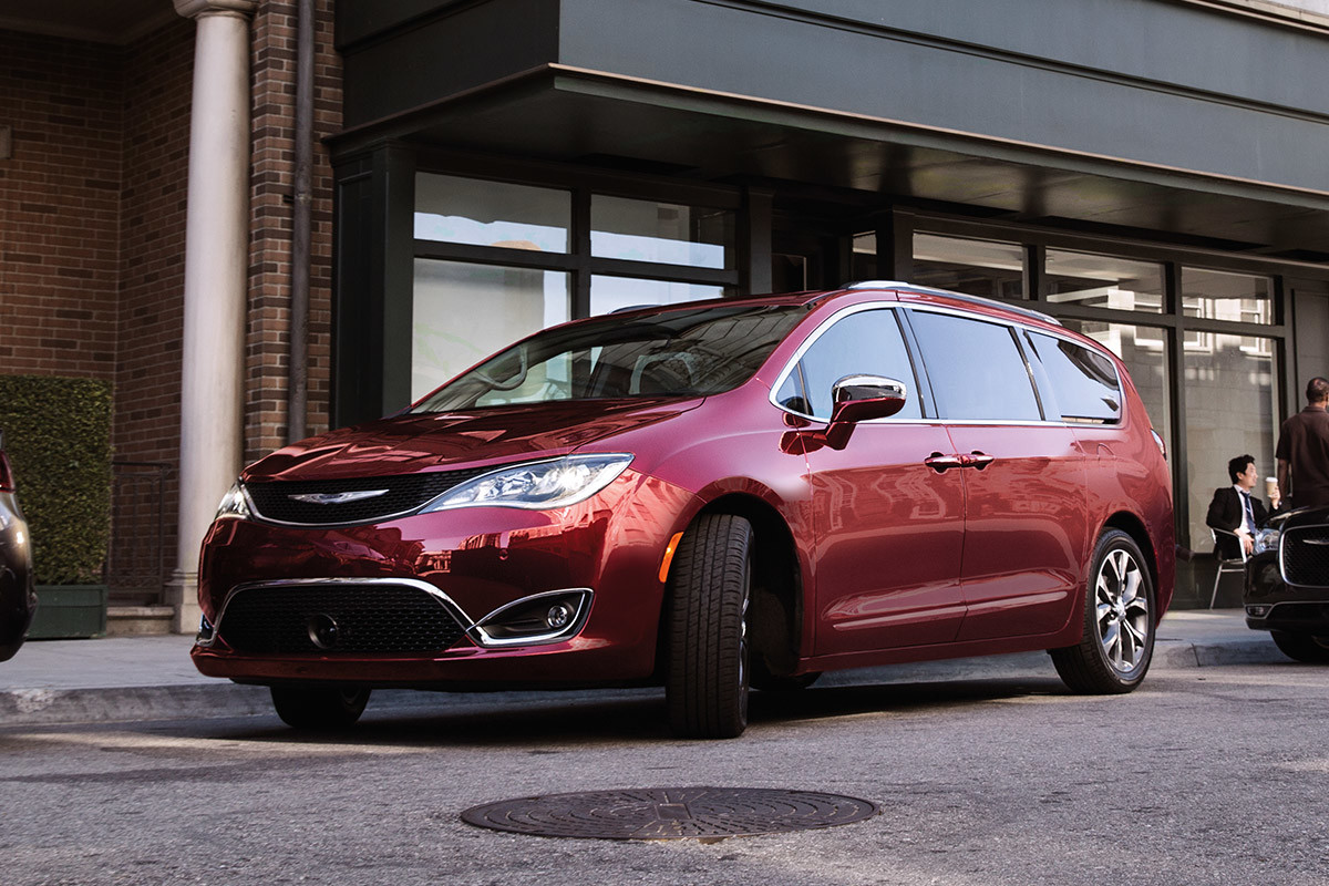 Red 2020 Chrysler Pacifica parked in front of a building.
