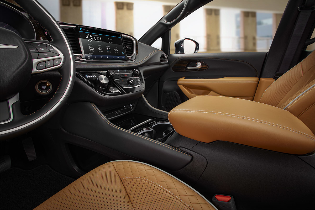 A close-up of the Caramel Nappa leather-faced seating and armrest inside the front area of a 2021 Chrysler Pacifica Pinnacle.
