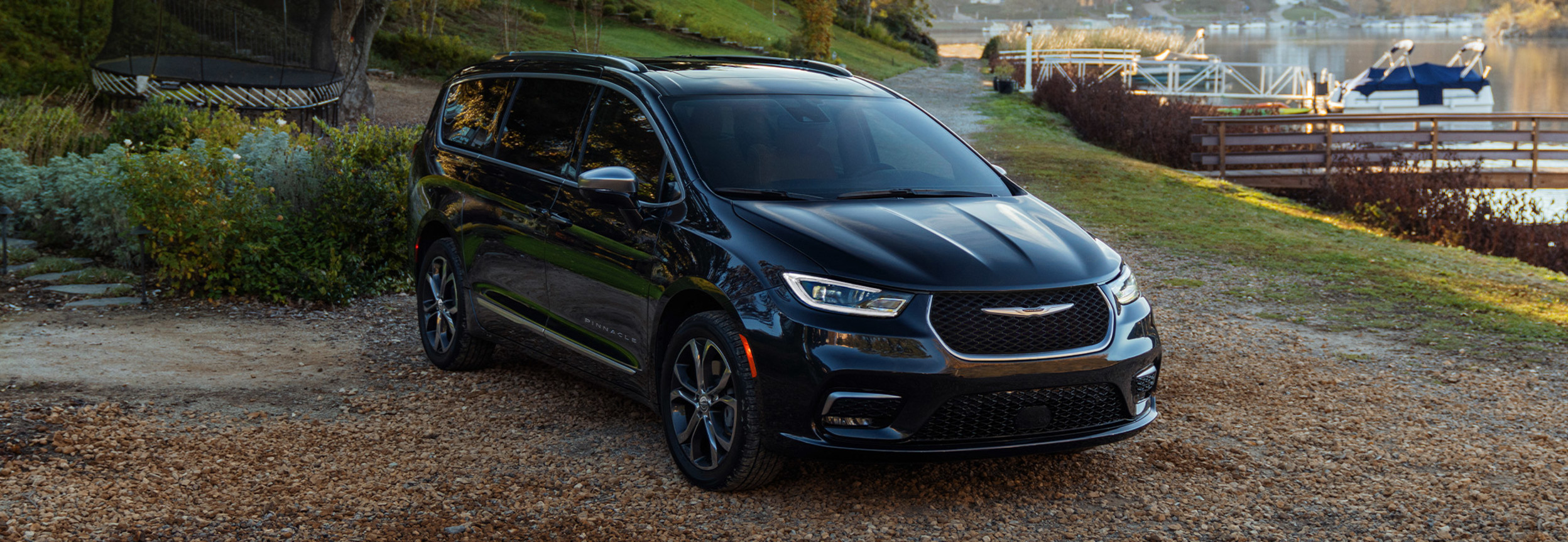 A black 2022 Chrysler Pacifica parked on a side road.