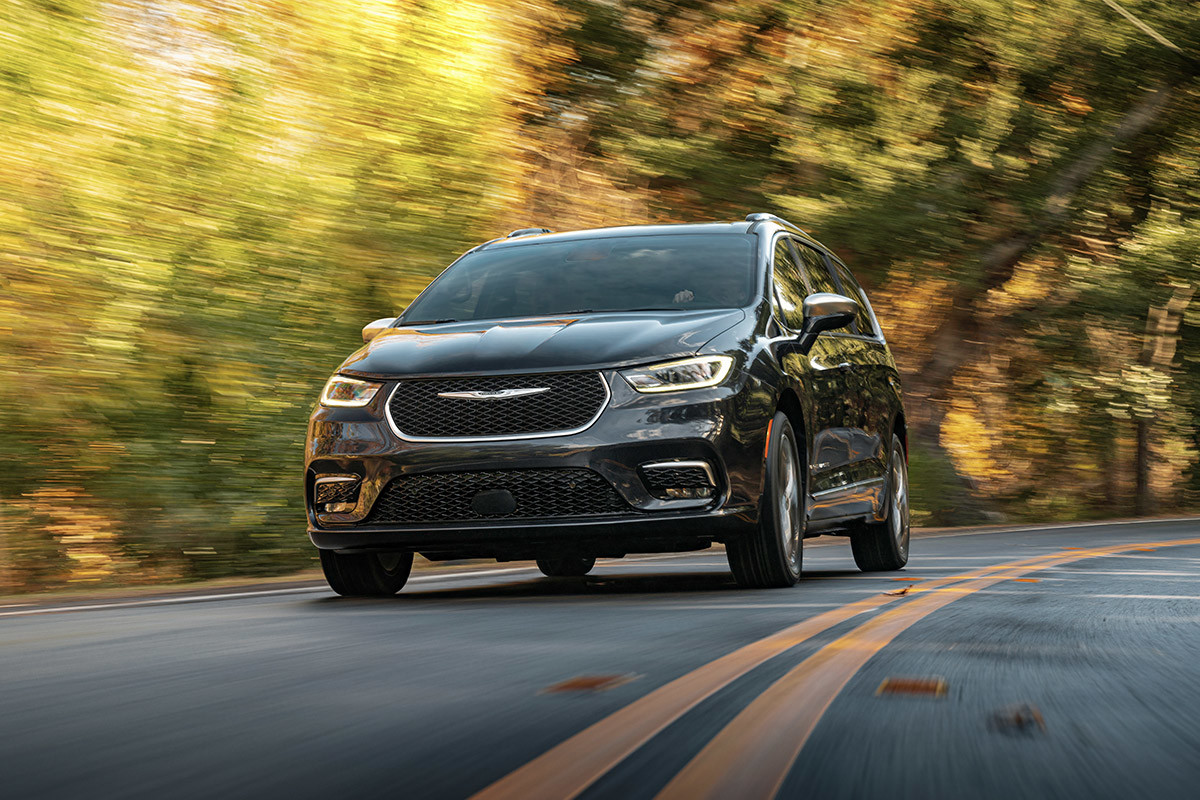 A black 2022 Chrysler Pacifica driving on a highway.