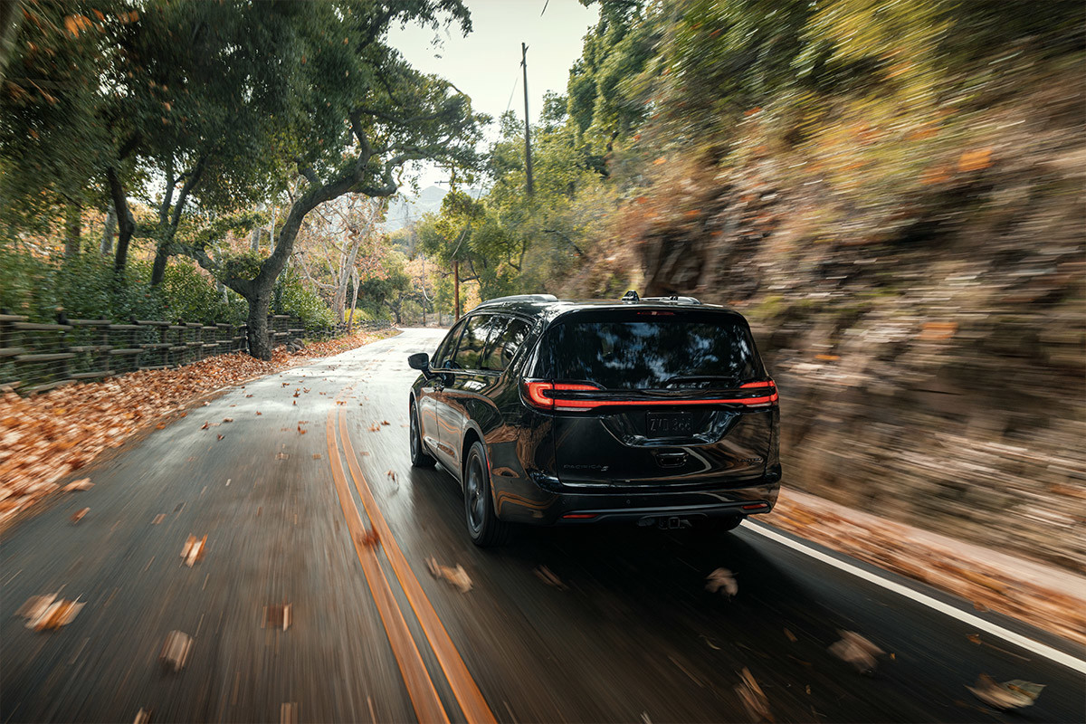 A black 2022 Chrysler Pacifica driving on a highway.