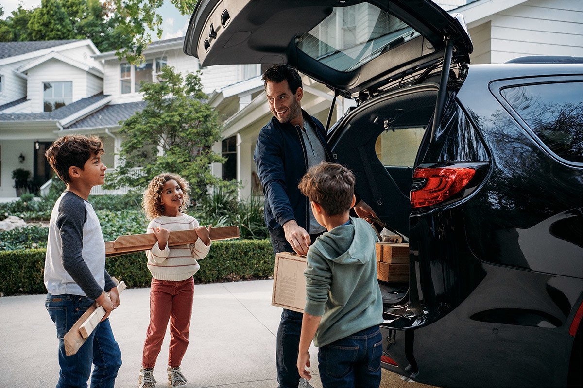 Rear shot of liftgate with children and one adult.