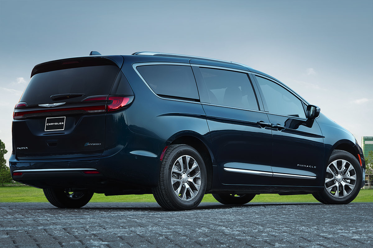 Side view of a 2021 Chrysler Pacifica Hybrid parked on a cobblestone road