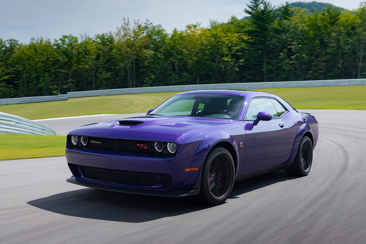 Purple Dodge Challenger Driving Around a Curve