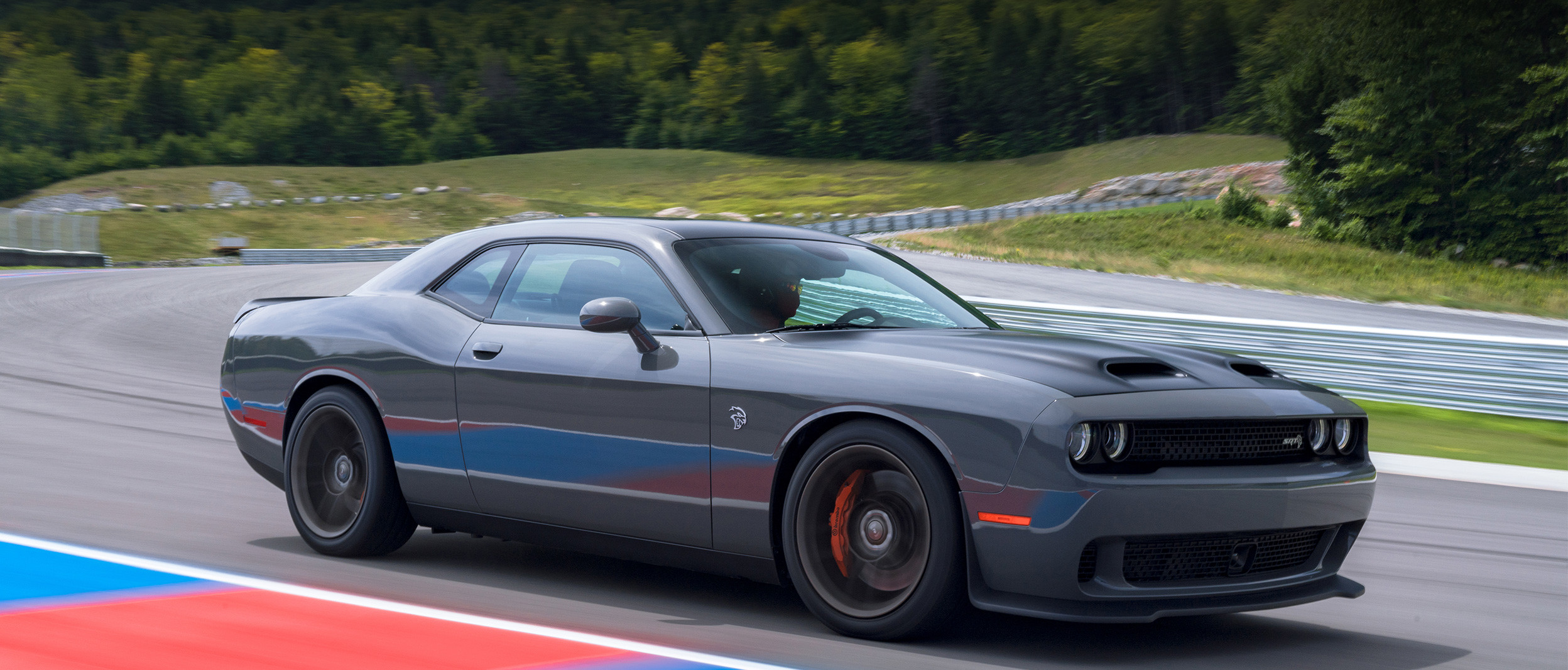 Grey 2019 Dodge Challenger being driven on an outdoor racing track.