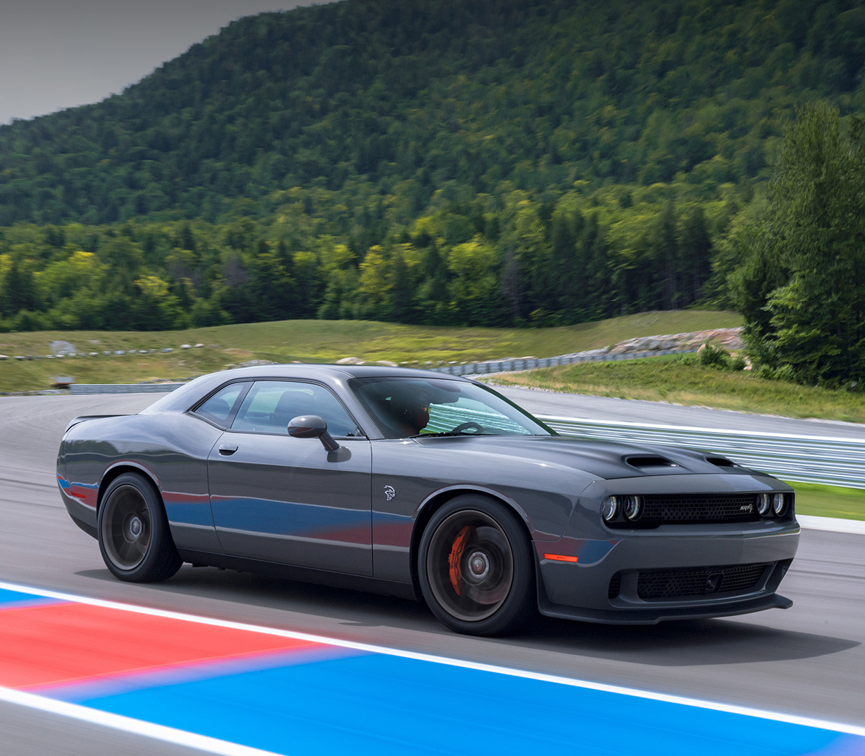 Grey 2019 Dodge Challenger being driven on an outdoor racing track.