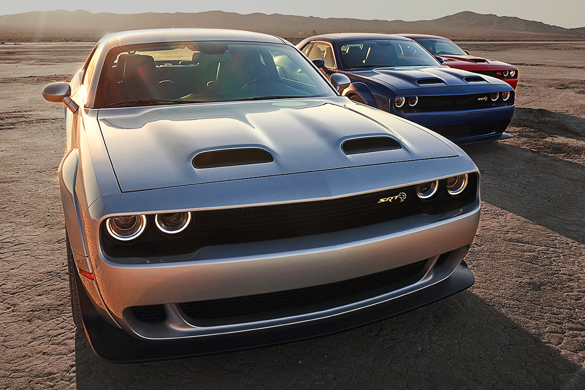 Three 2020 Dodge Challengers parked in a parking lot