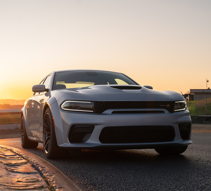 White 2021 Dodge Charger on the road at sunset
