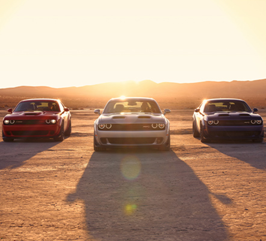 3 2021 Dodge challenger in the desert