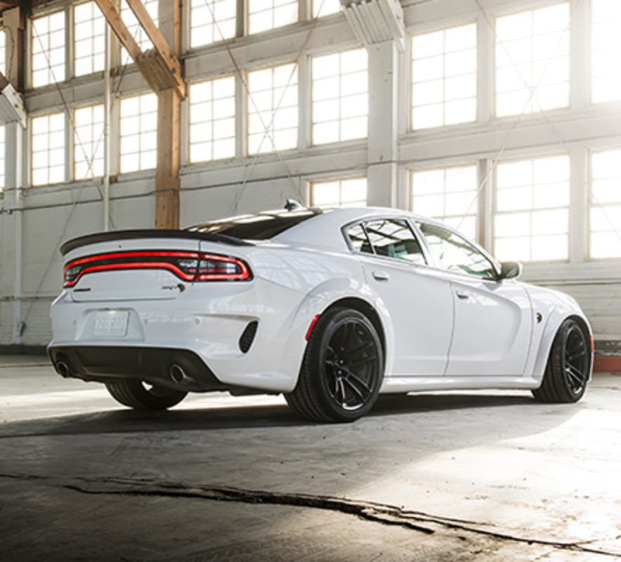 2021 white Doge Charger parked in the garage