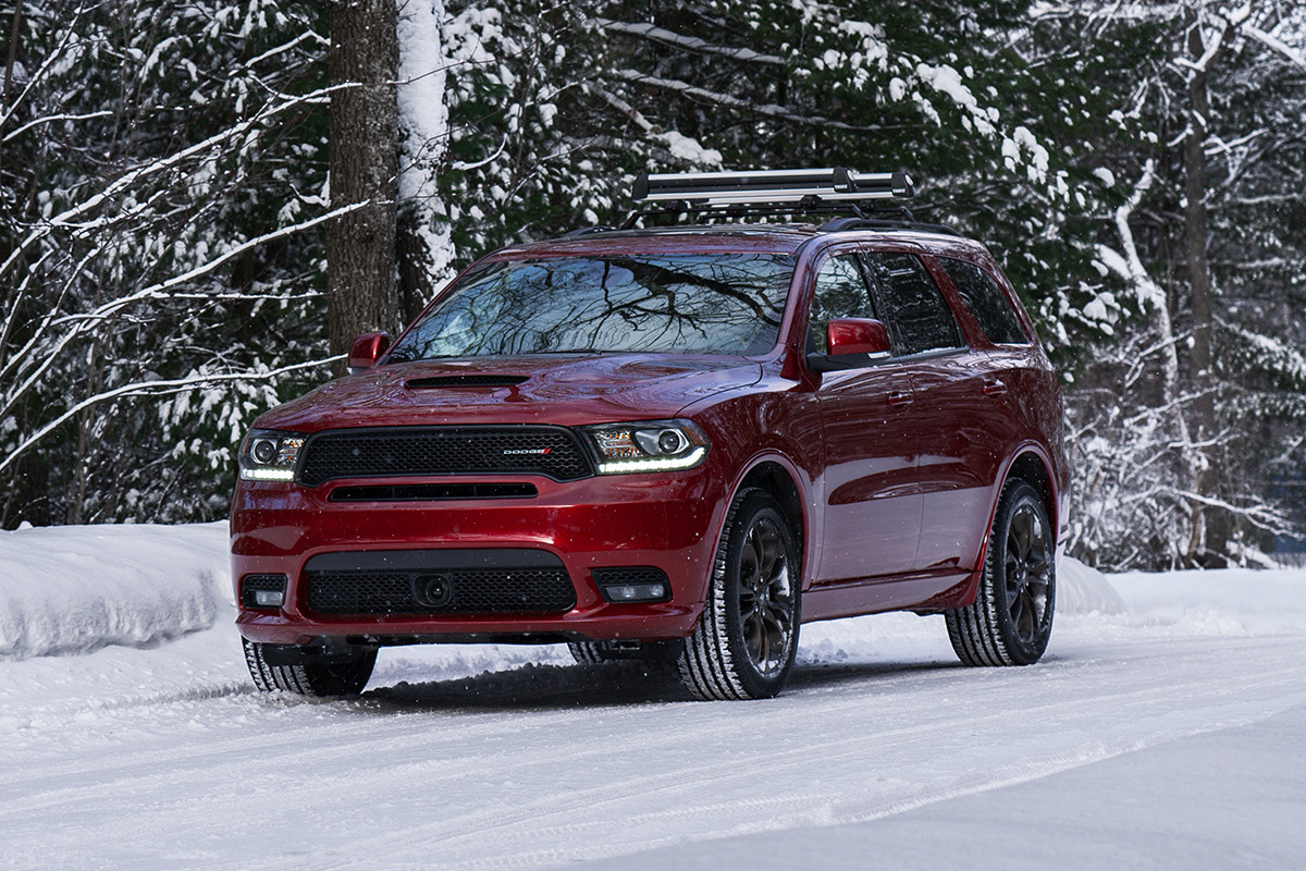 Front view of the red 2019 Dodge Durango driving on a snowy road in the forest